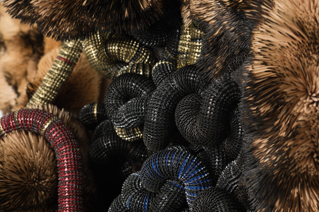 Chimera, 2024, Discarded Beer Bottle Caps threaded onto Electric Fencing Cable, held in Polyurethane Sealant on Board, with Burnt and Unburnt Bamboo and Birch Wood Toothpicks_Photographer_ Matt Slater, Courtesy Piero Atchugarry Gallery and the Artist